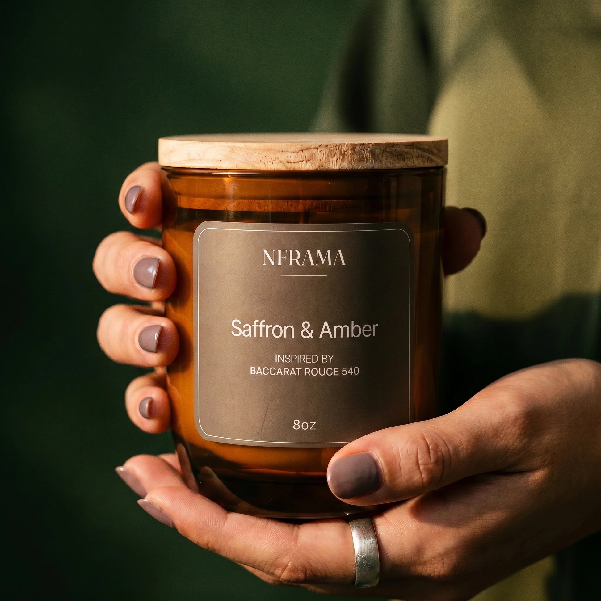 Hand holding the Saffron & Amber candle
